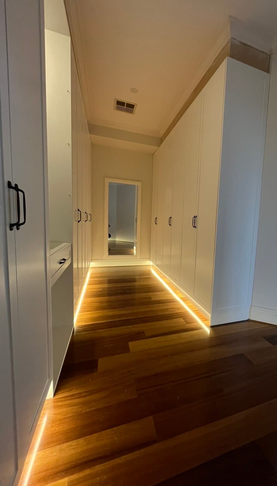 Ambient LED floor lighting in walk-in closet